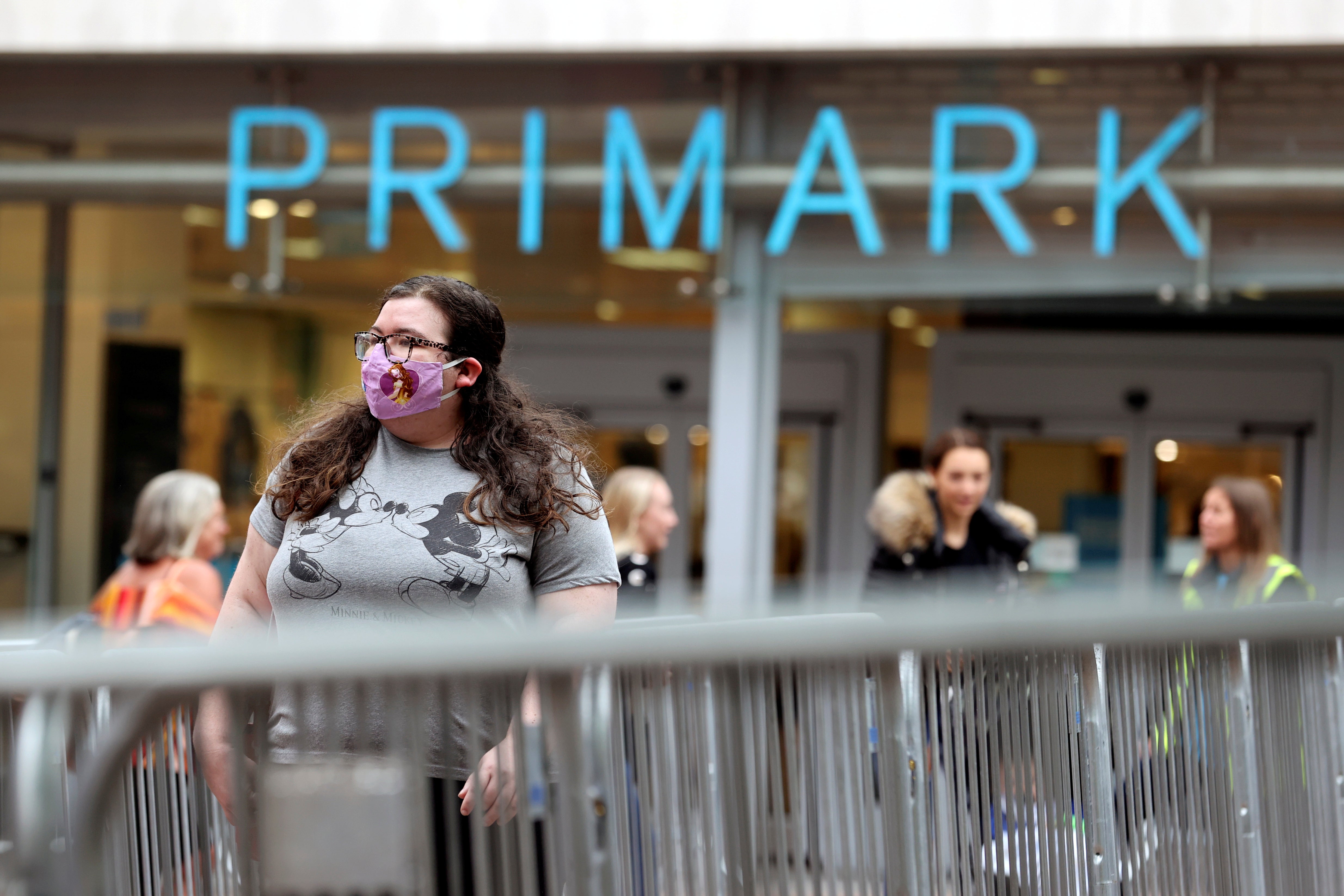 People queue outside a Primark store, after the branch's reopening amid the coronavirus disease