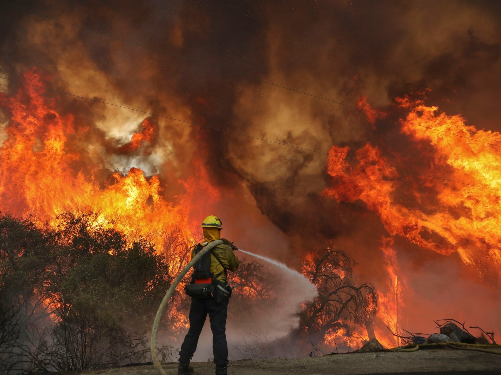 San Miguel County Firefighters battle a brush fire along Japatul Road during the Valley Fire in Jamul, California over the weekend 