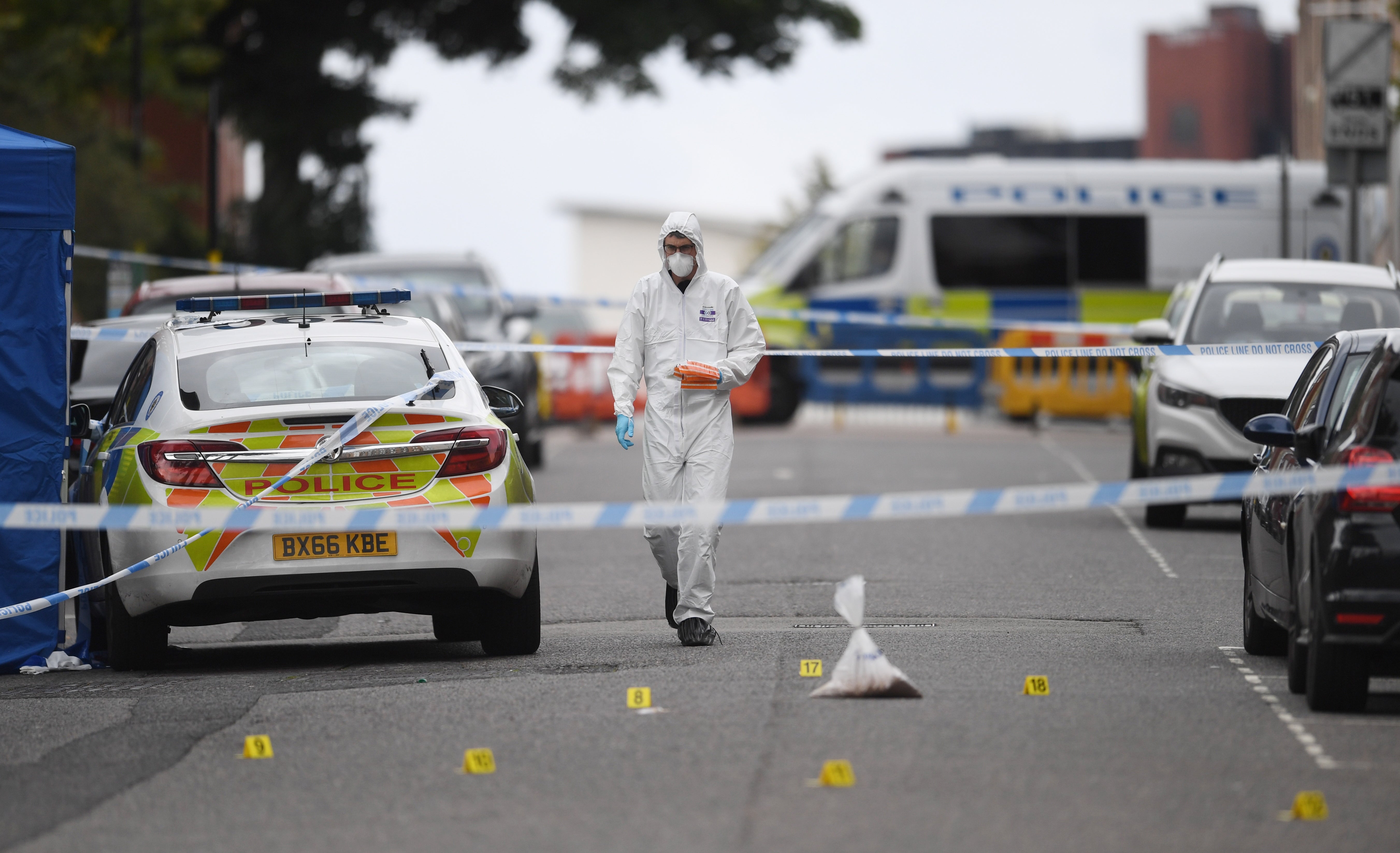 A forensics officer investigates the scene of a stabbing in Birmingham