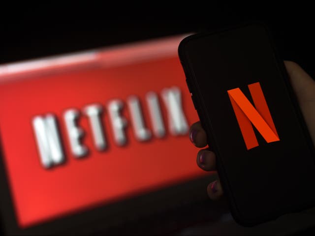 The Netflix logo is displayed on a phone and computer screen