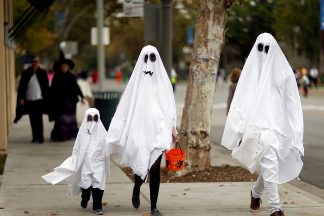 Trick or Treaters walk the streets