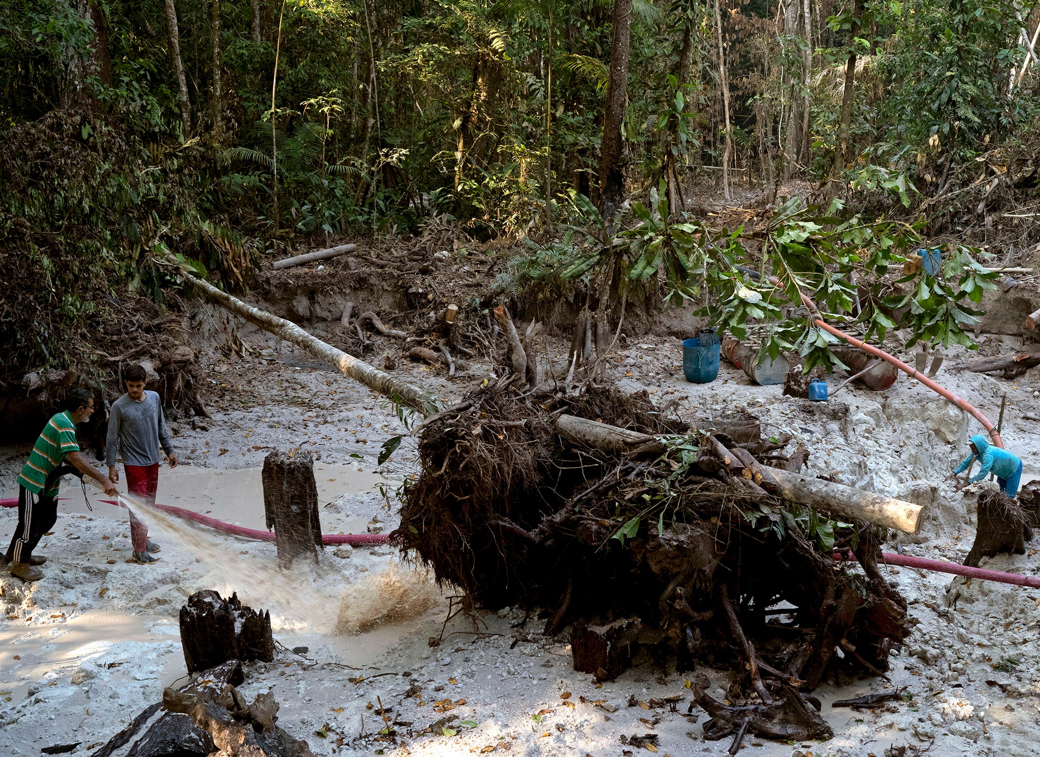 Miners work in a ravine at an illegal site in the Amazon