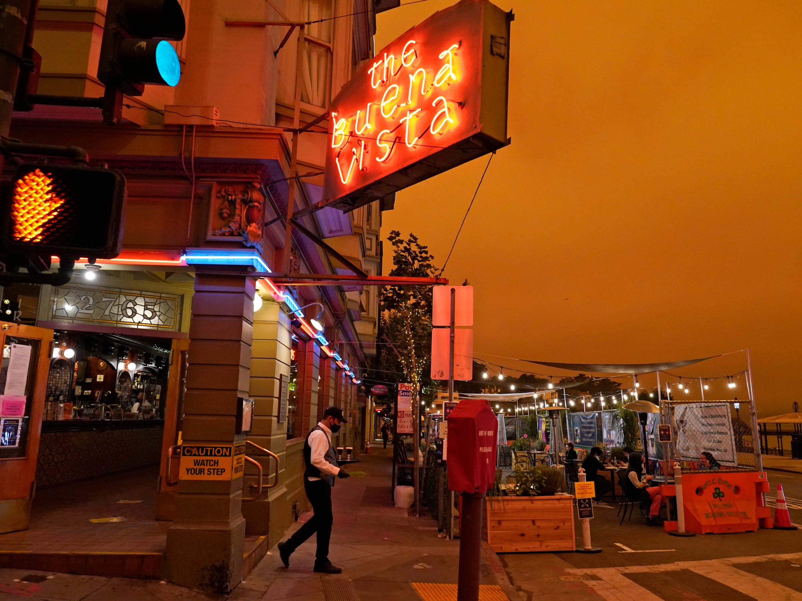 ‘Like a scene from Mars’: Terrifying pictures show California turning orange as wildfires rage on