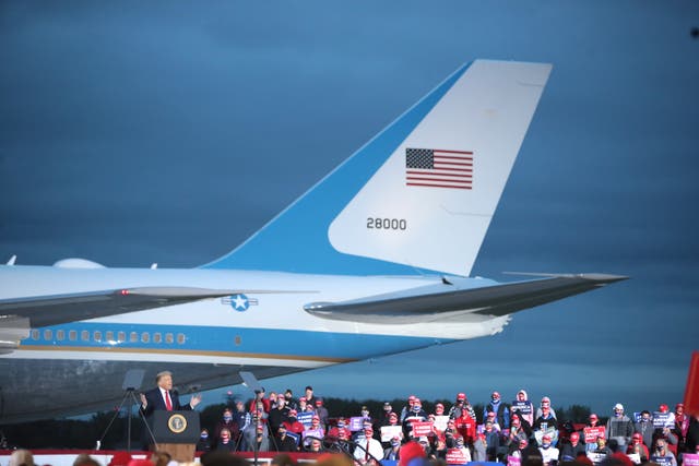 Donald Trump talks to a rally crowd in front of Air Force One