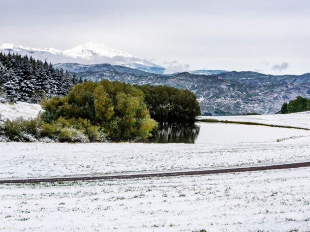 Snow covers the ground near a pond on Red Mountain in Aspen, Colorado, on Wednesday, Sept. 9, 2020. The state has seen wild variations in temperature in the past week