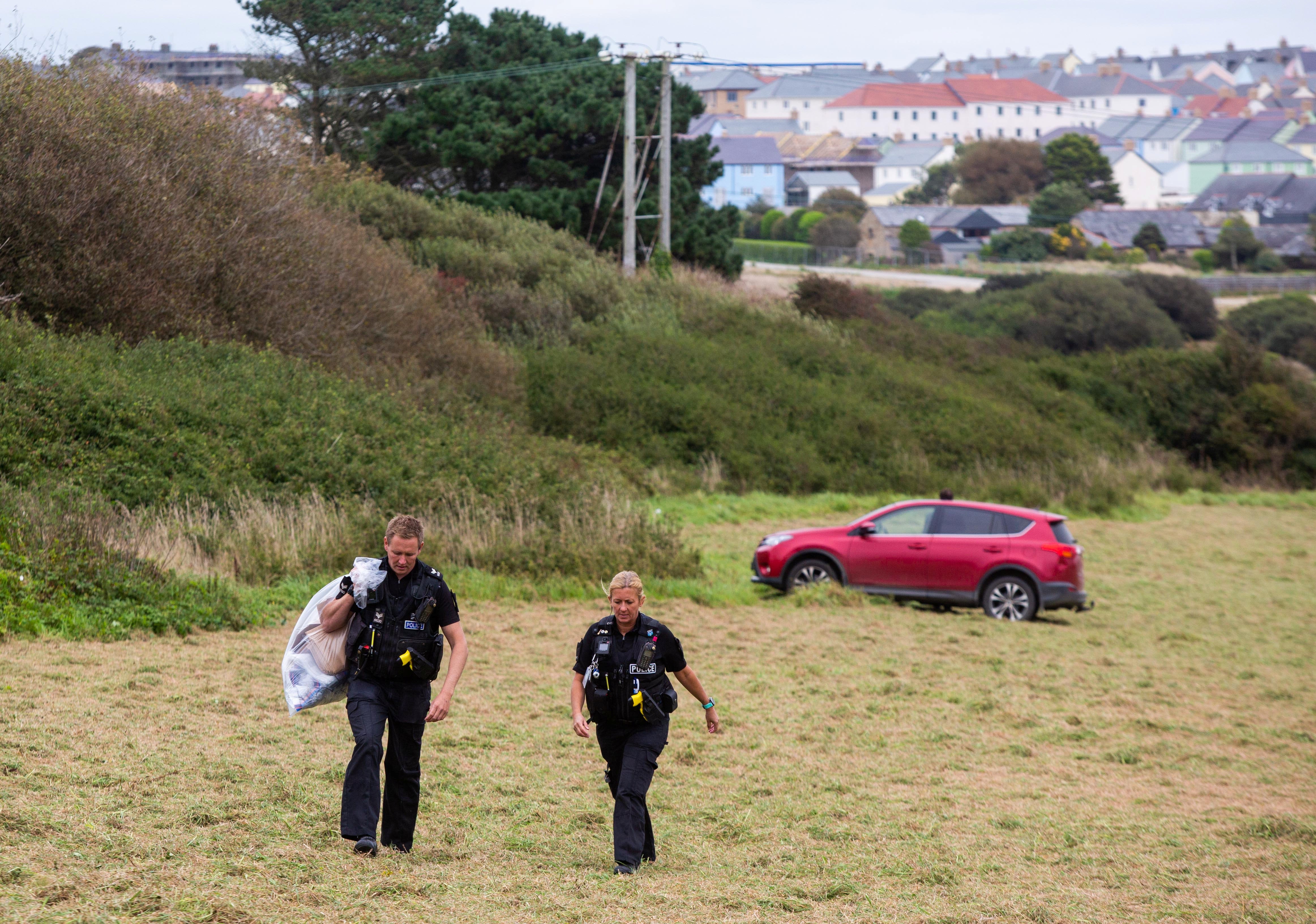 Police attend a field off Trevenson Road in Newquay where an officer suffered burns to his arms and leg