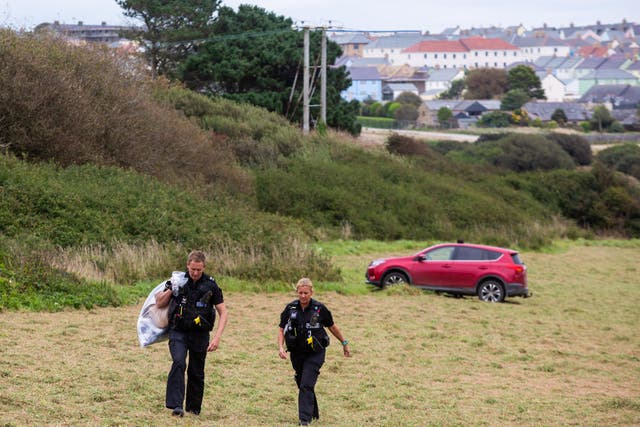 Police attend a field off Trevenson Road in Newquay where an officer suffered burns to his arms and leg