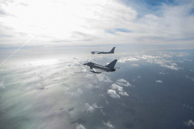 A photo issued by the MoD shows a Eurofighter Typhoon (near) and a Russian Bear F aircraft (far)
