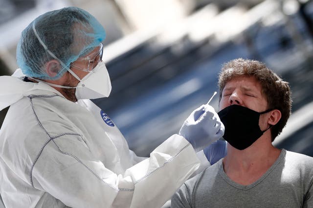 A medical worker takes a nose swab samples at a test station for Covid-19 coronavirus in Montpellier, France