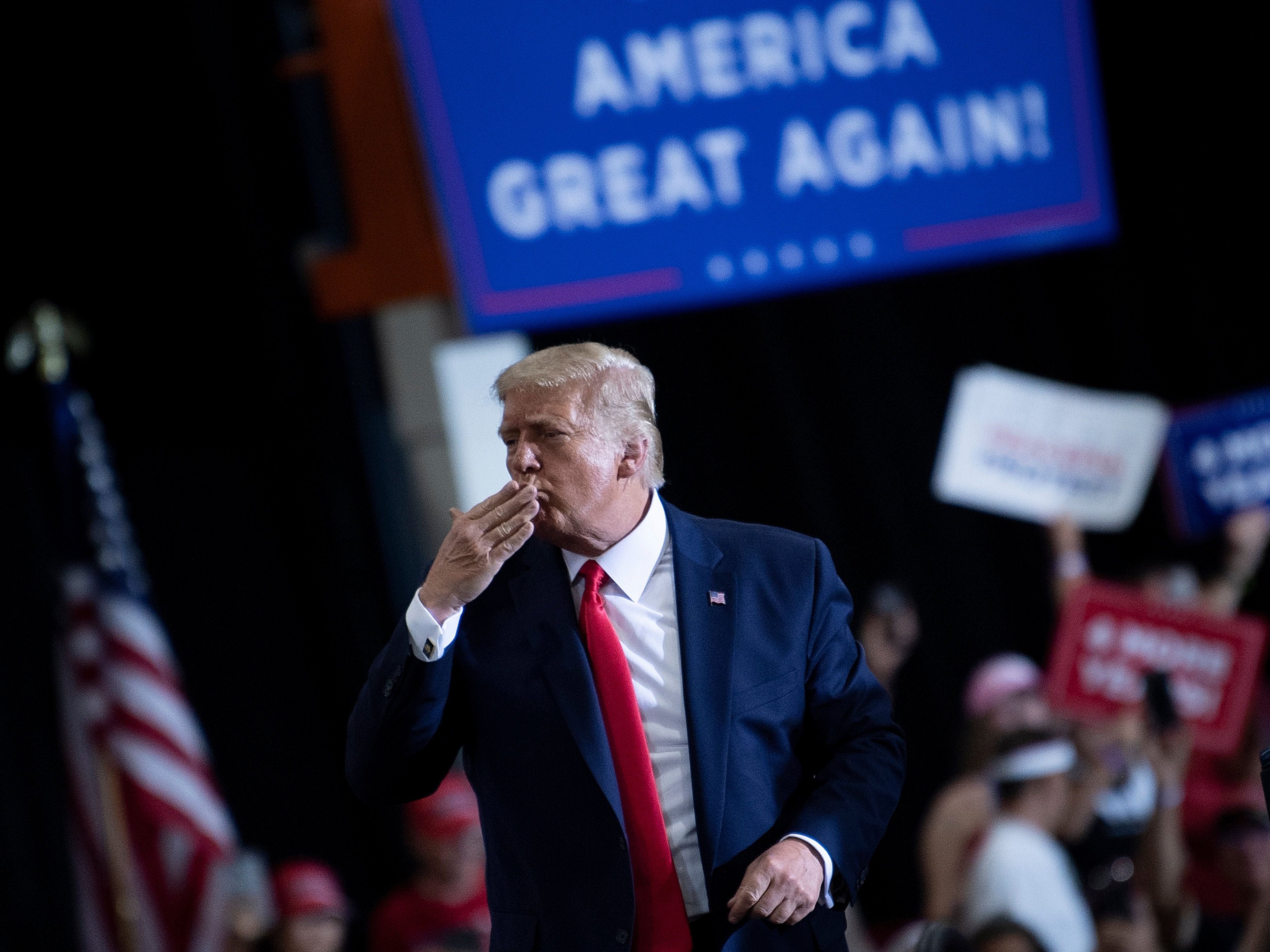 US President Donald Trump blows a kiss to supporters after speaking during an indoor campaign rally at Xtreme Manufacturing in Henderson, a suburb of Las Vegas, Nevada