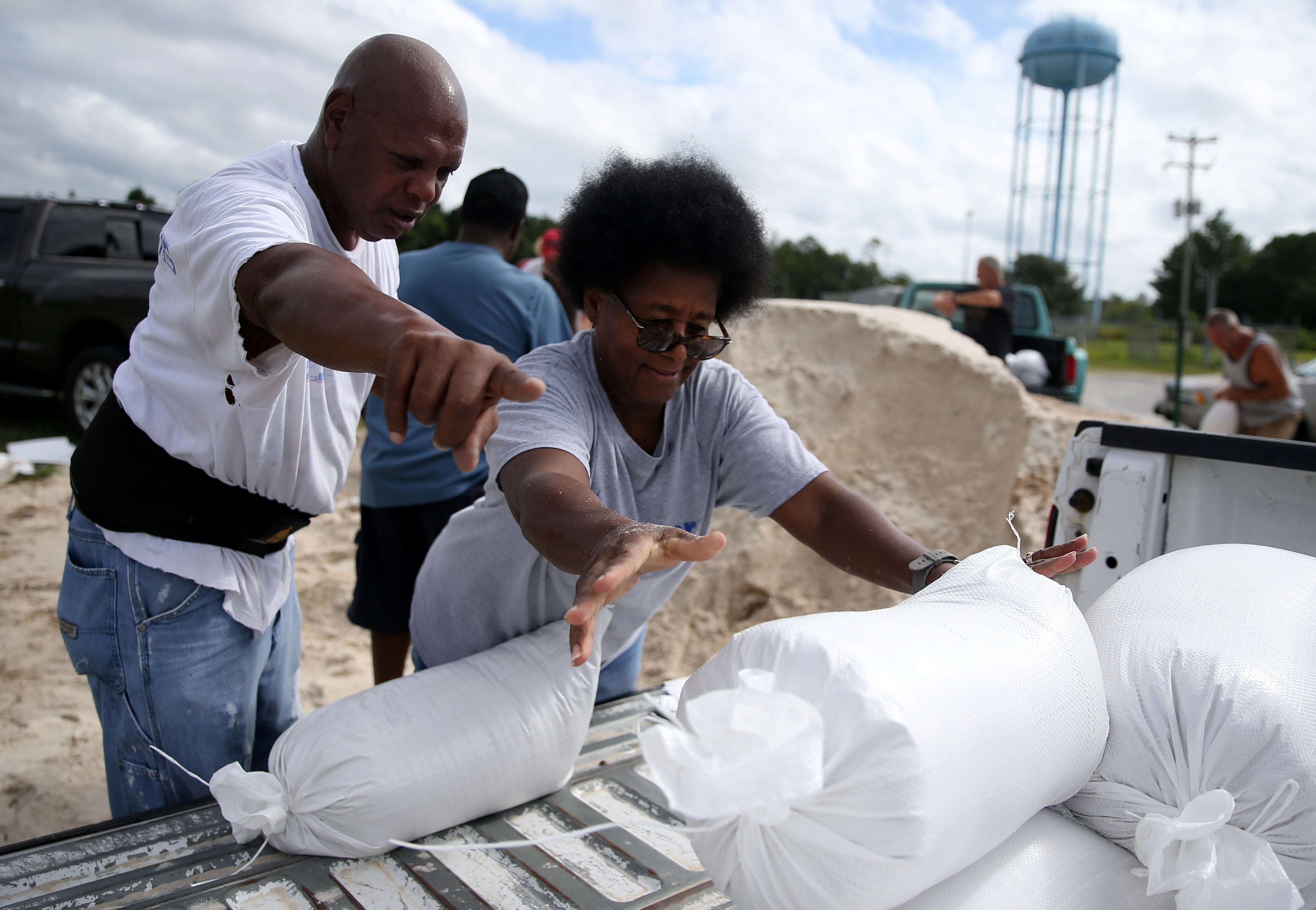 Mississippi residents Sam Dorsey and Dianne Fredrick load sandbags in preparations for storm Sally