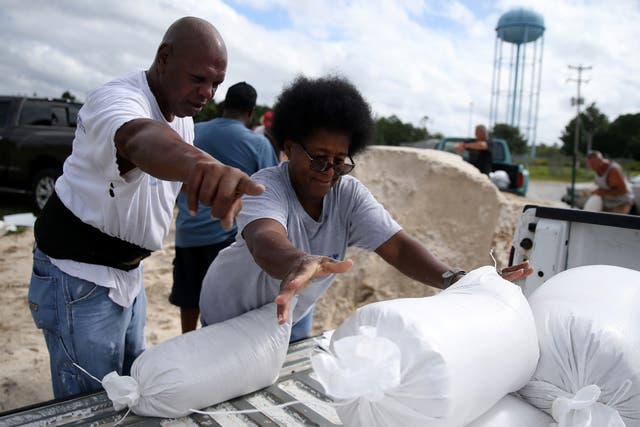 Mississippi residents Sam Dorsey and Dianne Fredrick load sandbags in preparations for storm Sally