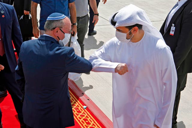 Israeli and Emirati officials greet ahead of their trip to the UAE