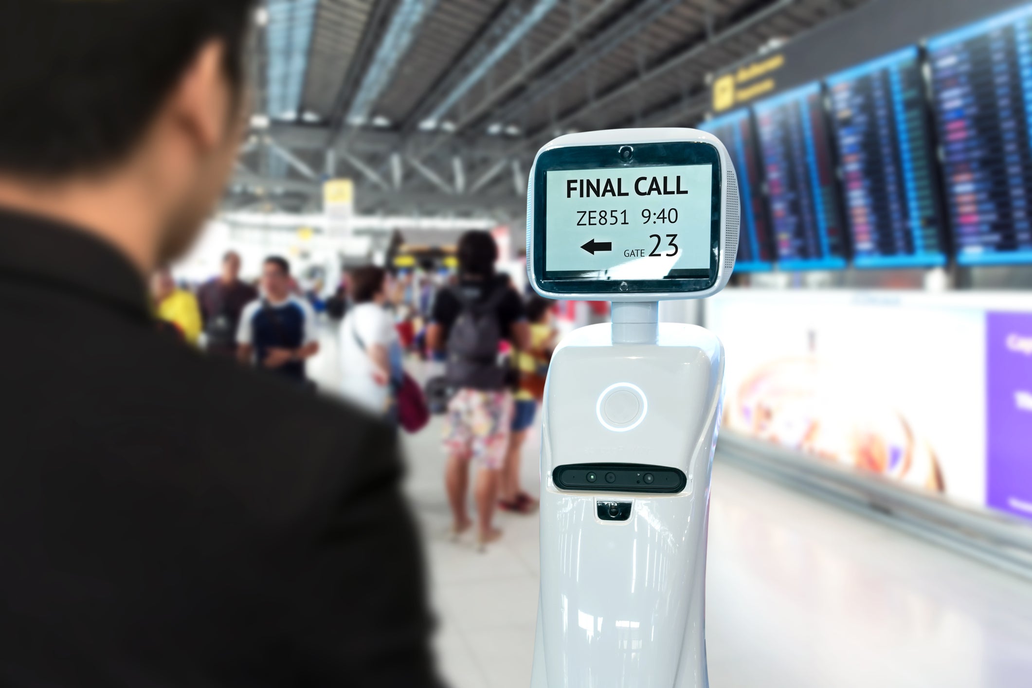 A self-driving check-in robot accompanies a passenger to their gate