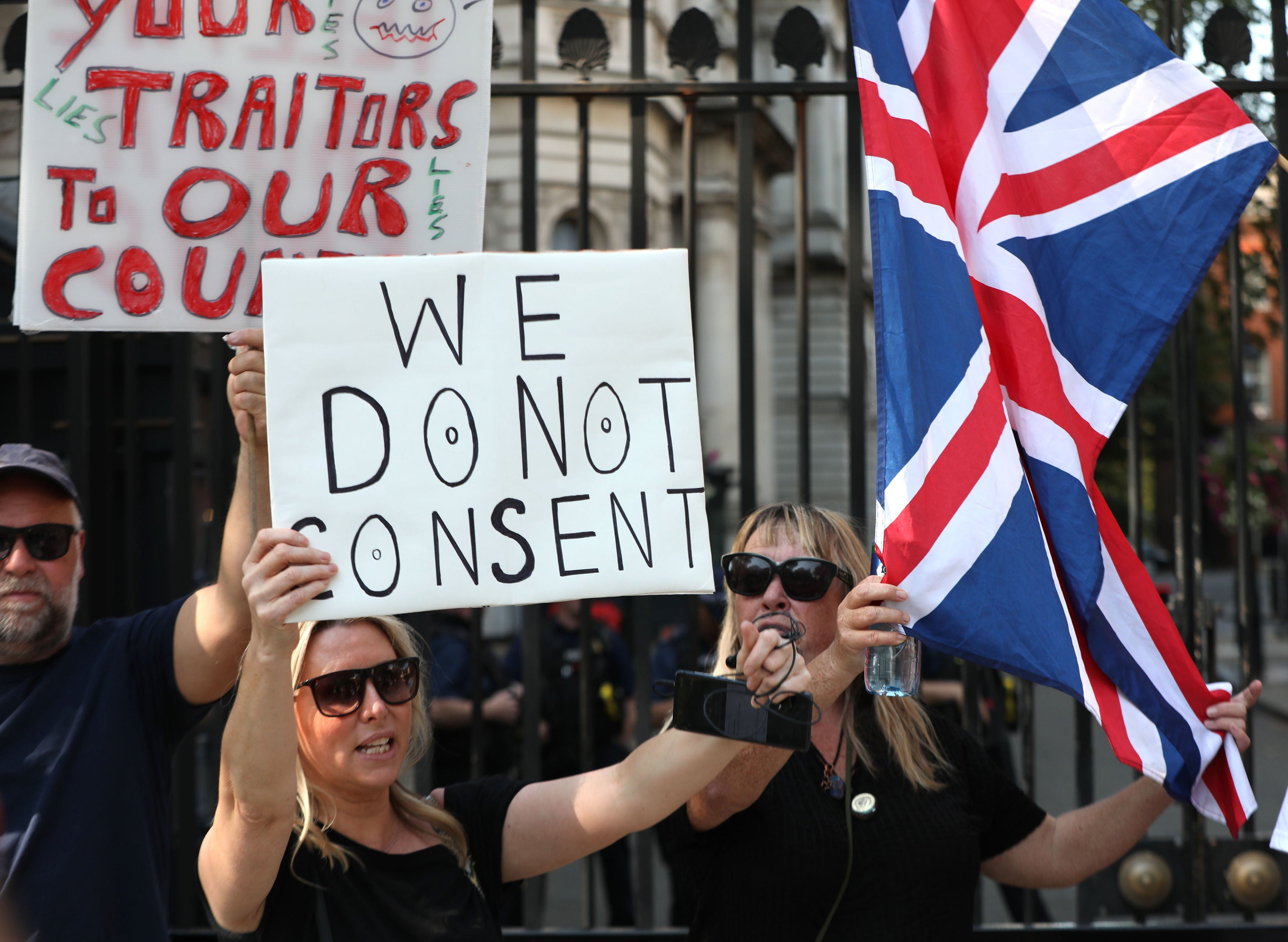 People mount small protest outside Downing Street as rule of six comes into effect