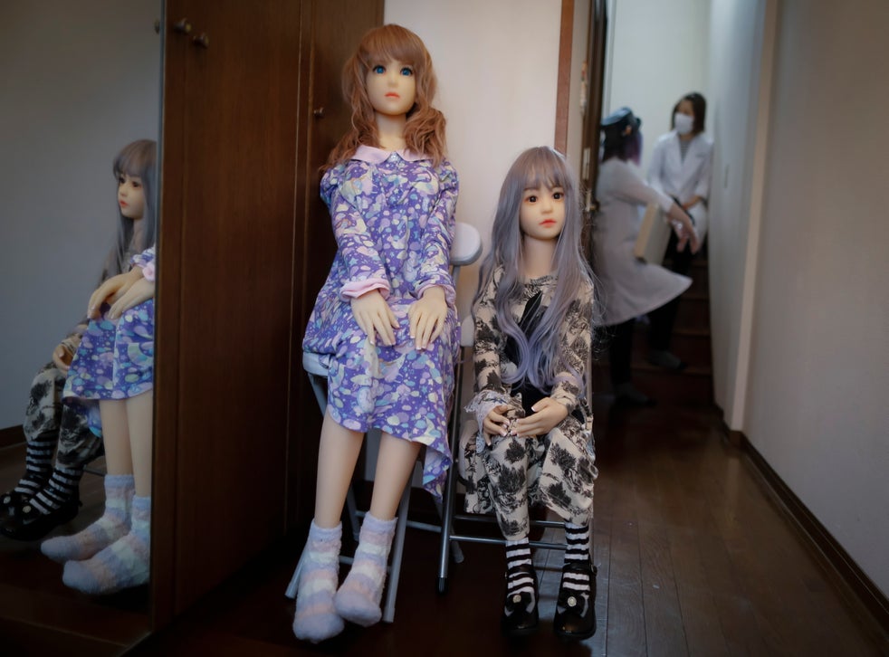Sex dolls named Sayaka ,left, and Rinne sit and welcome visitors at the entrance of the Human-Love Doll Factory