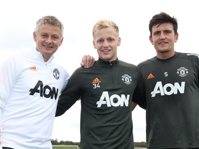 Ole Gunnar Solskjaer poses with Donny van de Beek and Harry Maguire