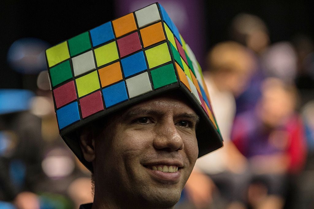A competitor wears a hat shaped like a cube during the Rubik’s Cube World Championship in Sao Paulo, Brazil, in 2015