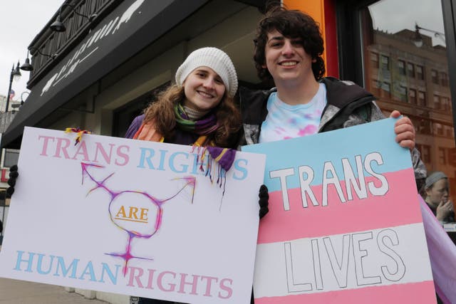 Students hold up signs at transgender rights protest in Chicago, 2017