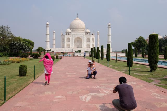 <p>A man gets his photograph taken in front of the monument</p>