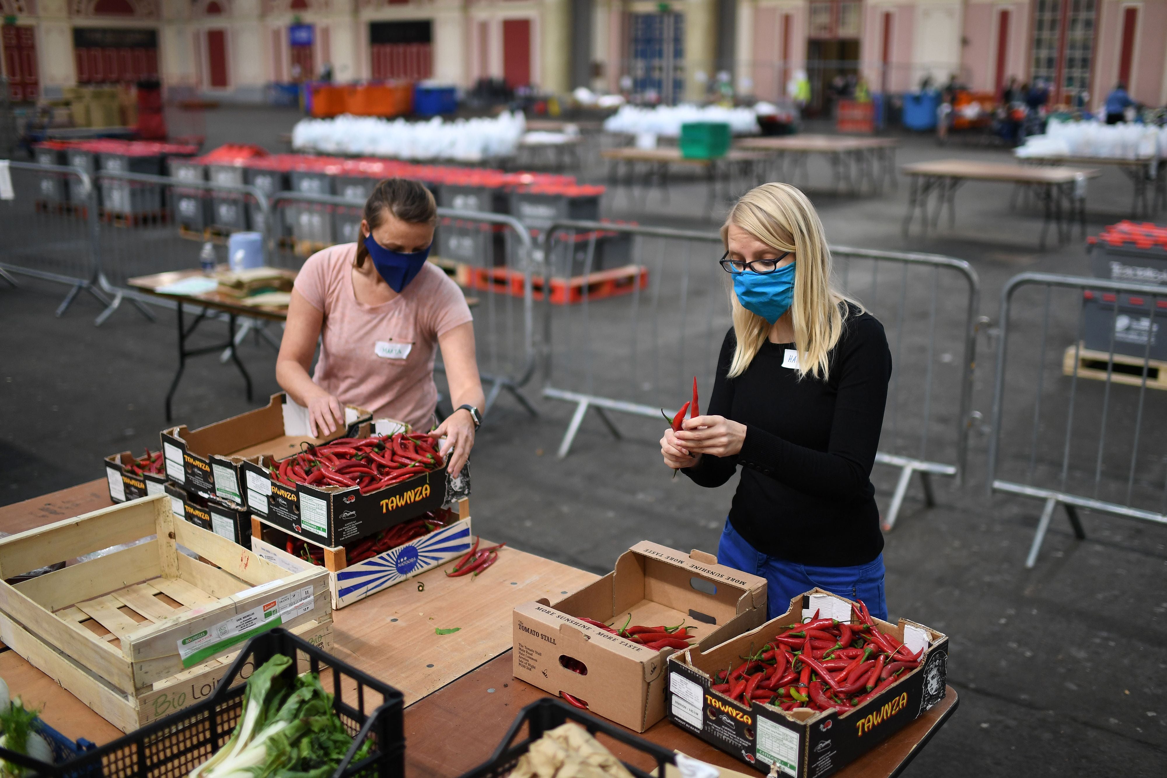 Volunteers at Edible London's temporary food bank sort food into parcels