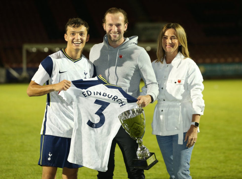 George Marsh of Tottenham Hotspur U23’s presents a shirt signed by the first team to Justin Edinburgh’s wife Kerri Edinburgh and son Charlie Edinburgh