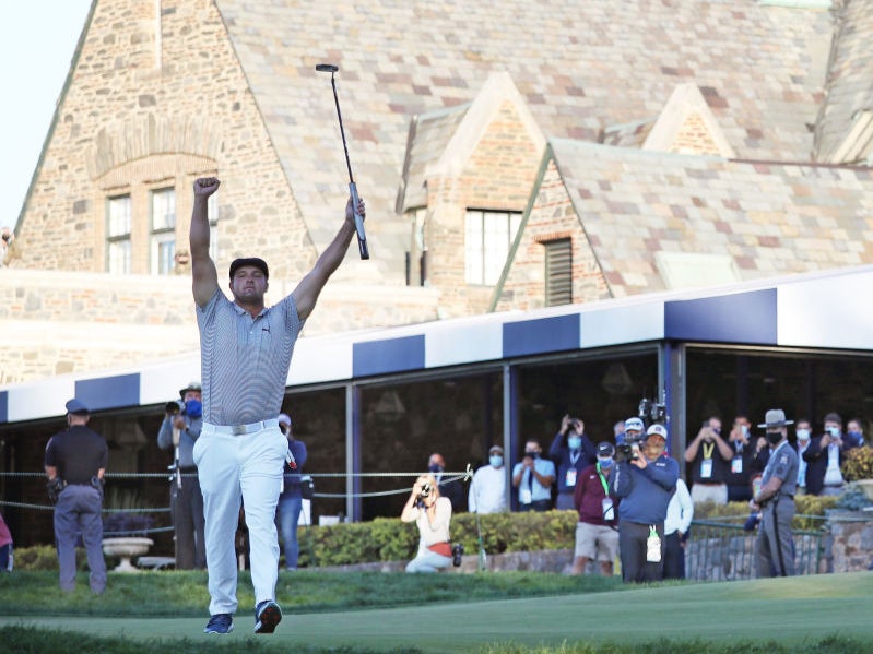 Bryson DeChambeau celebrates on the 18th green at Winged Foot