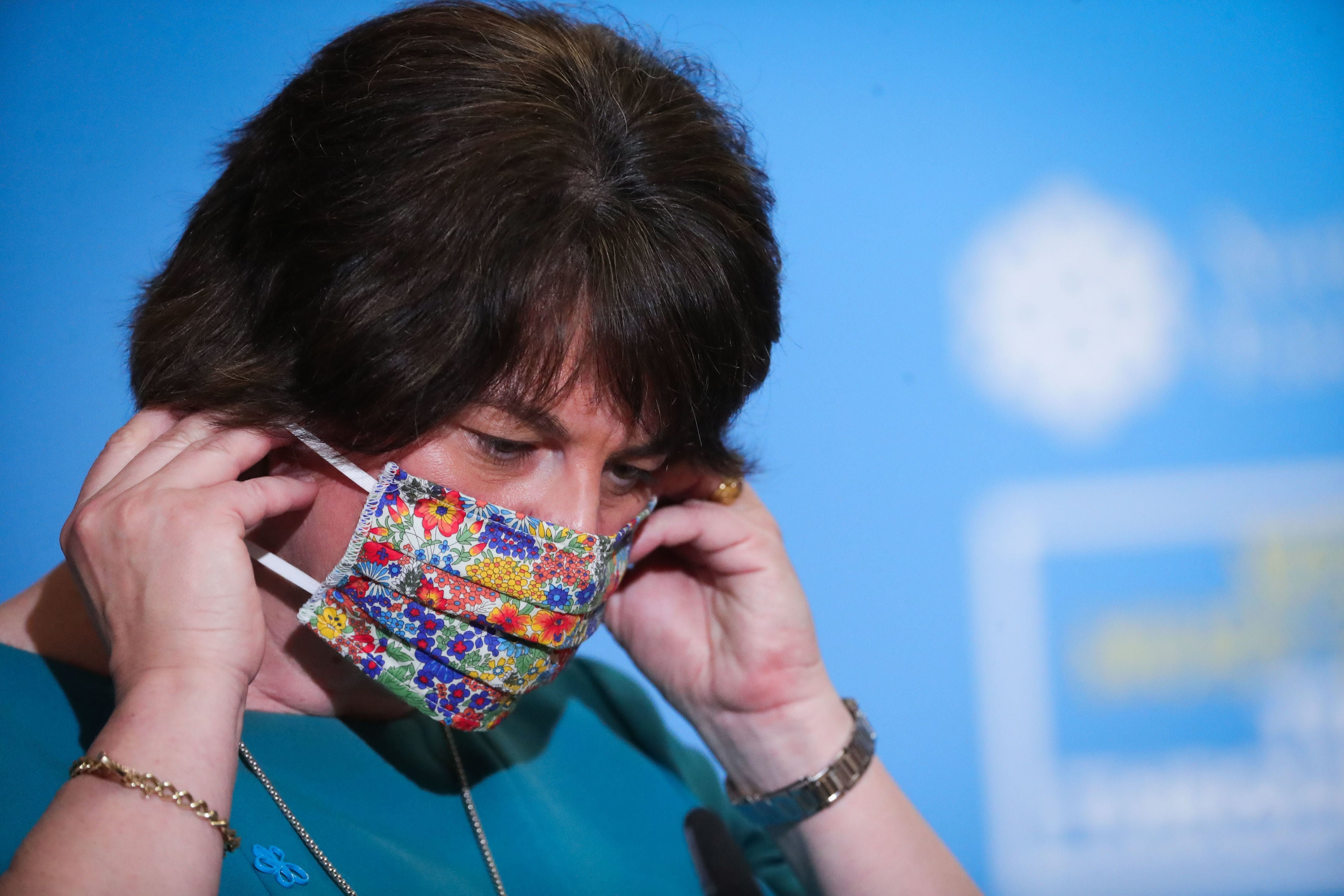 Northern Ireland first minister Arlene Foster removes her face covering before announcing new restrictions