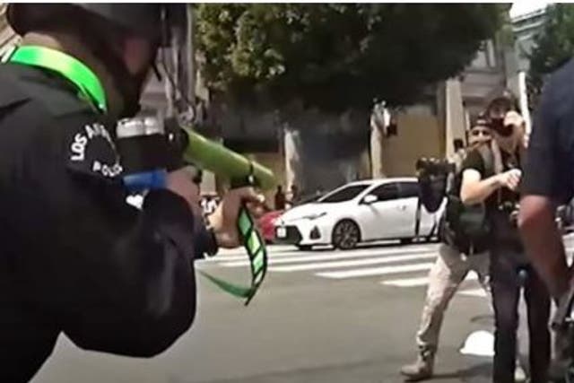 A Los Angeles Police Officer shoots a "less lethal" 40mm foam round at the groin of a protester who had been complying with an officer moments earlier