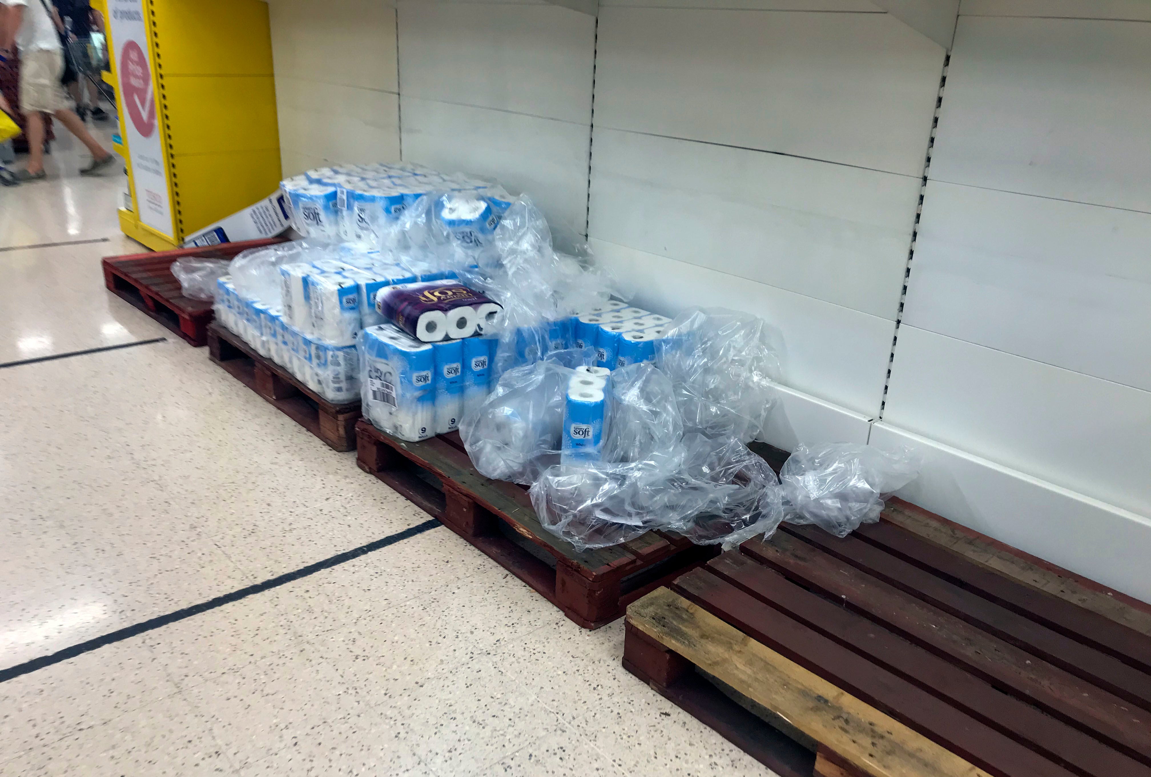 Depleted stocks and empty pallets in the toilet roll aisle at the Portsmouth North Harbour Tesco