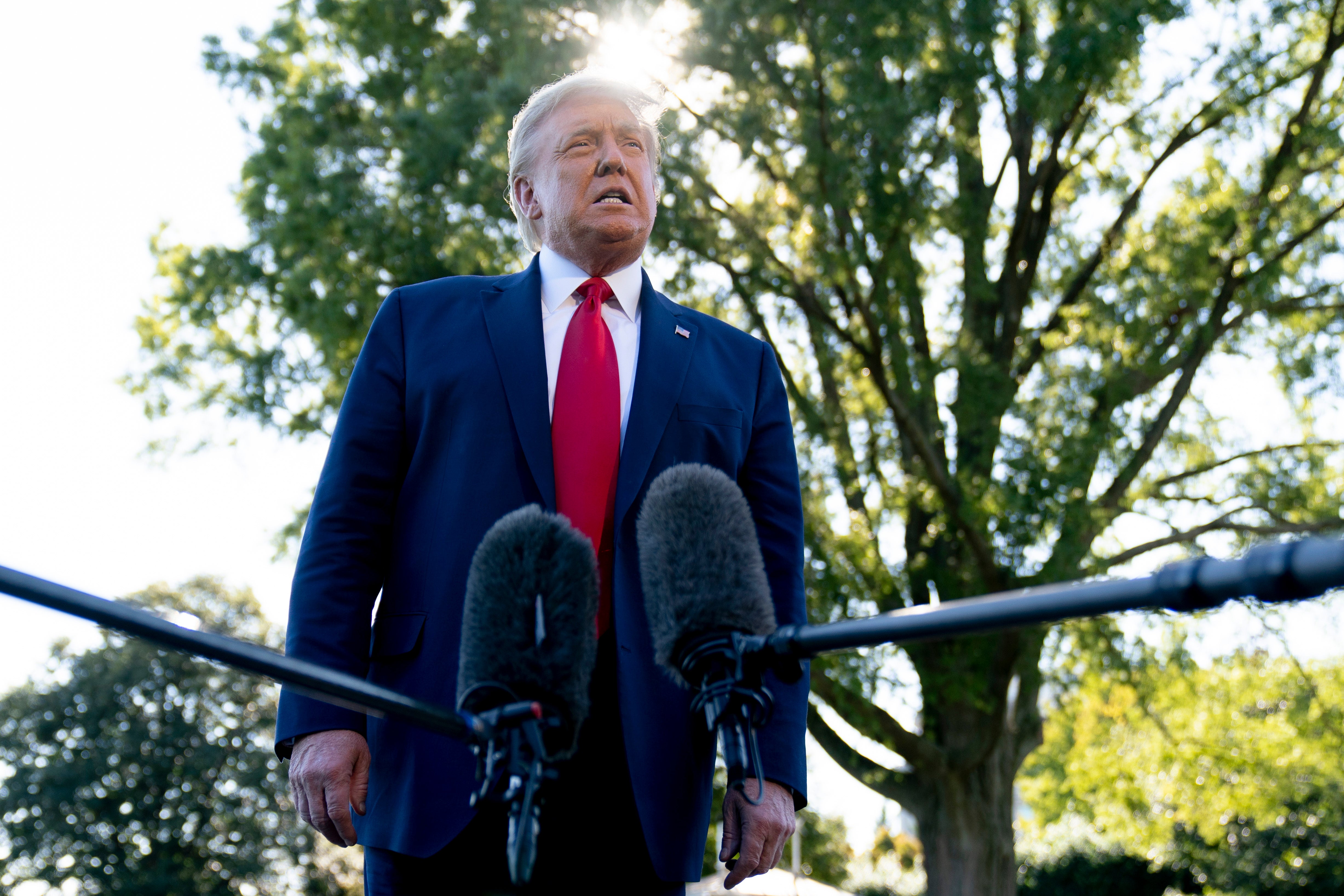 Donald Trump speaks to reporters before boarding Marine One on the South Lawn of the White House on 21 September.