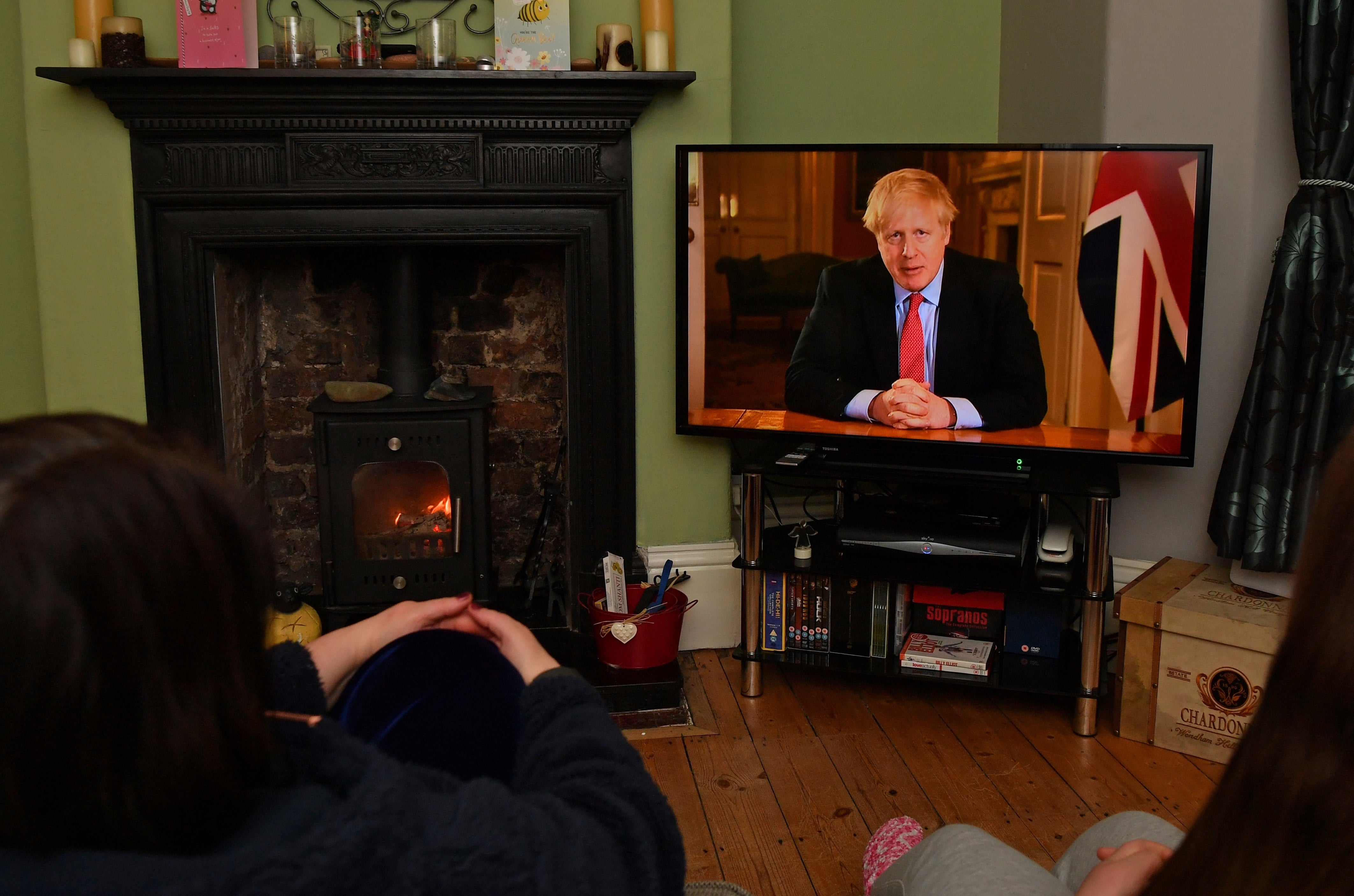 A family look on as Boris Johnson makes his televised lockdown address on 23 March