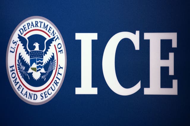 The Immigration and Customs Enforcement (ICE) seal is seen before a press conference discussing ongoing enforcement efforts to combat human smuggling along the Southwest border of the United States on 22 July 2014 at ICE headquarters in Washington, DC