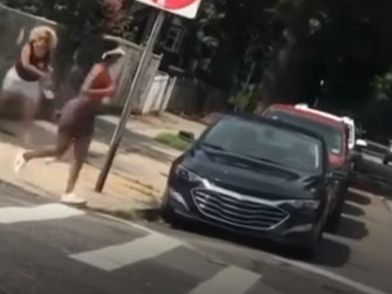 Woman charged with hate crime after filmed attack on black jogger
