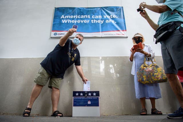 An American citizen in Thailand submits his absentee ballot for the 2020 US elections.