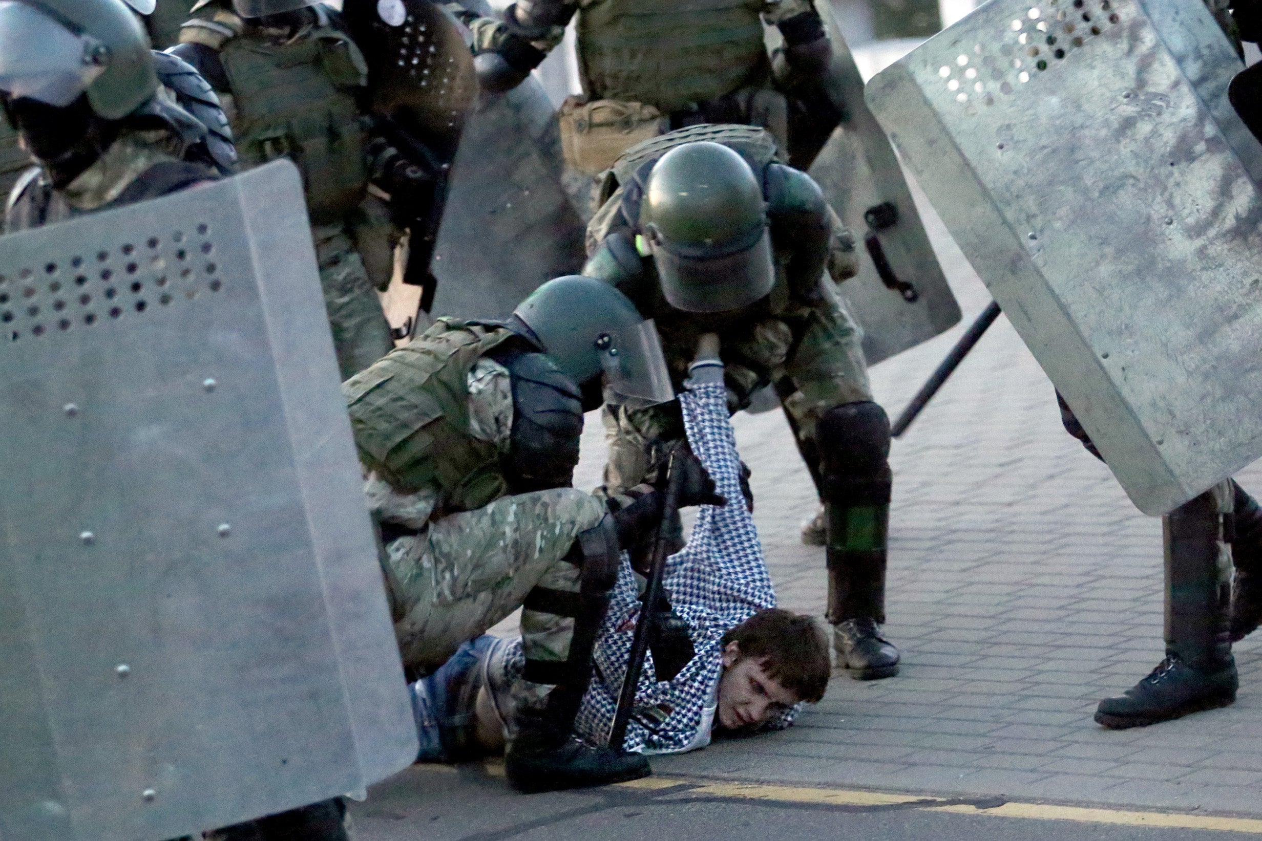 Police detain a man during an opposition rally in Minsk