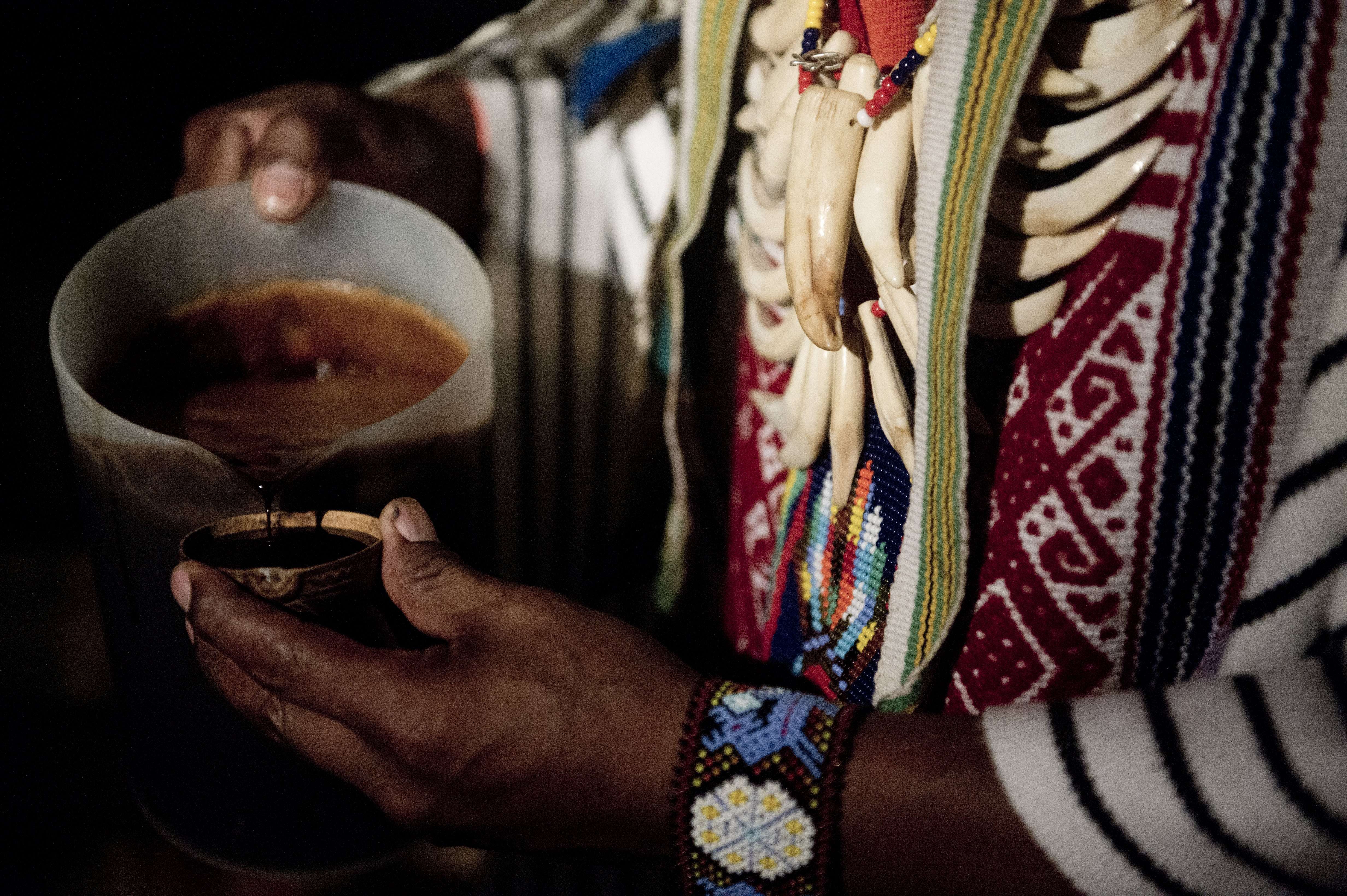 A healer starts a Yage ceremony in La Calera, Colombia. Yage, a mixture of the Ayahuasca hallucinogenic liana and a psychoactive bush, attracts many people in Colombia, who seek to participate in a traditional indigenous ritual of spiritual and physical healing