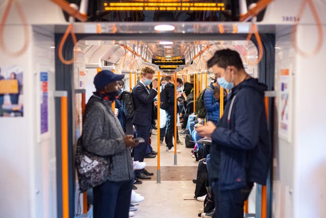 Commuters on board a London Overground train after Prime Minister Boris Johnson announced a range of new restrictions to combat the rise in coronavirus cases in England
