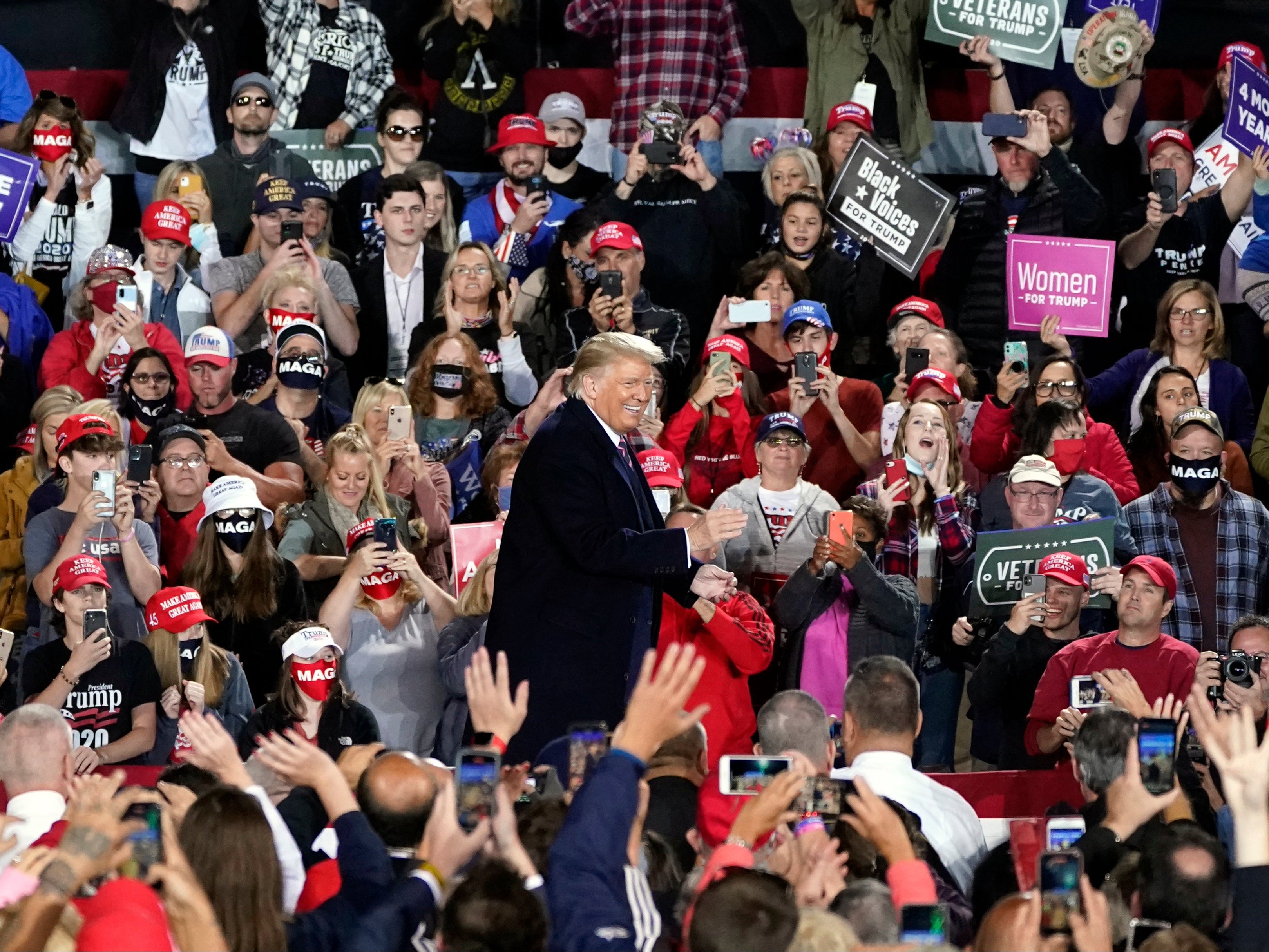 Donald Trump, surrounded by supporters, at a campaign rally.