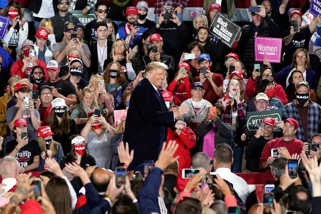 Donald Trump, surrounded by supporters, at a campaign rally.