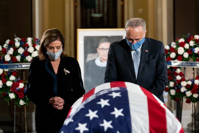 Speaker Nancy Pelosi and Senate Minority Leader Chuck Schumer pause by the casket of Justice Ruth Bader Ginsburg.