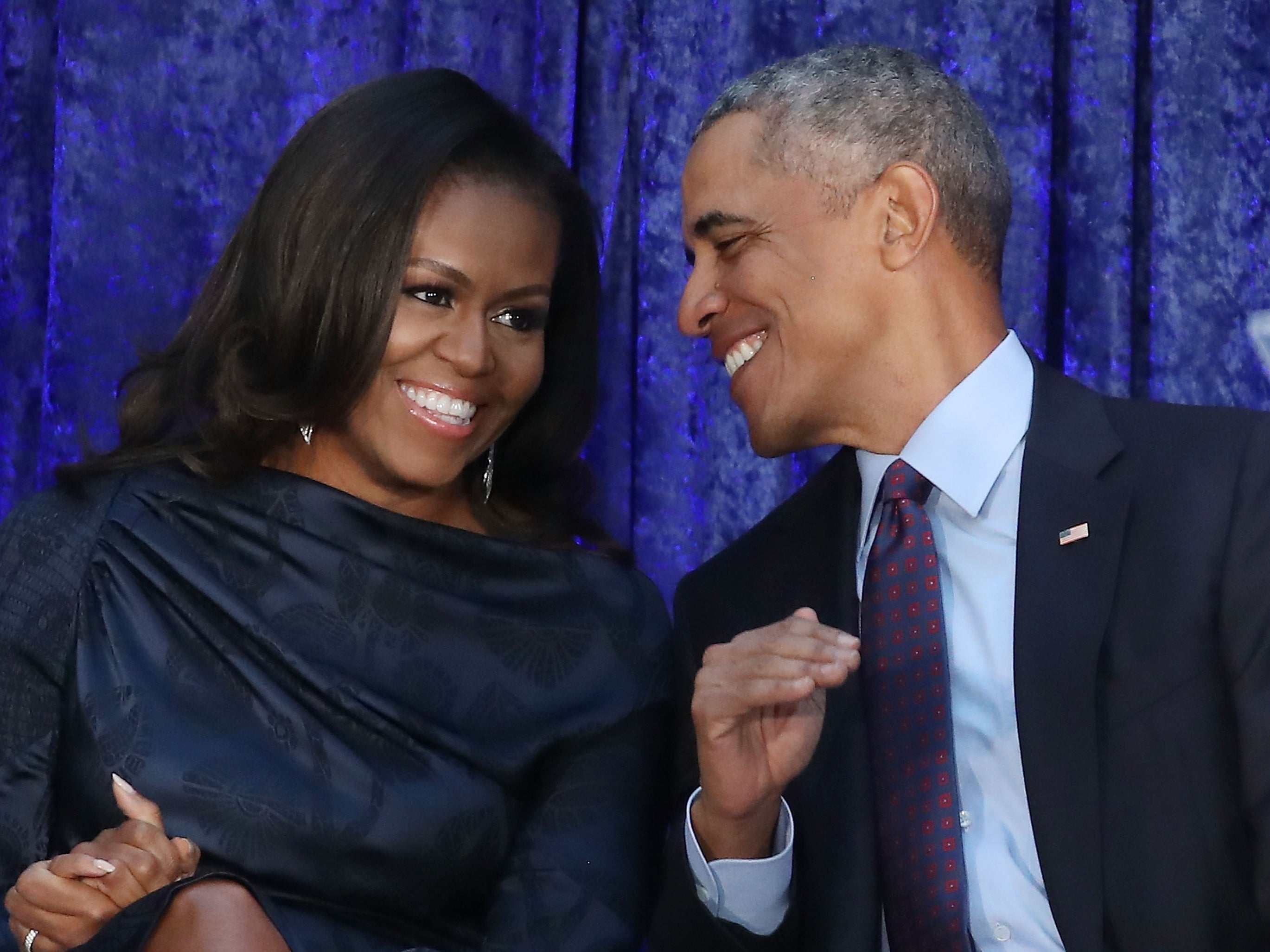 Former US President Barack Obama and first lady Michelle Obama participate in the unveiling of their official portraits