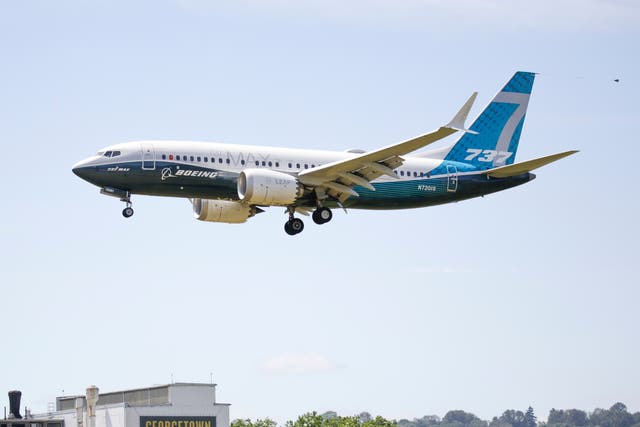 A Boeing 737 MAX jet lands following an FAA test flight at Boeing Field in Seattle, Washington, in June