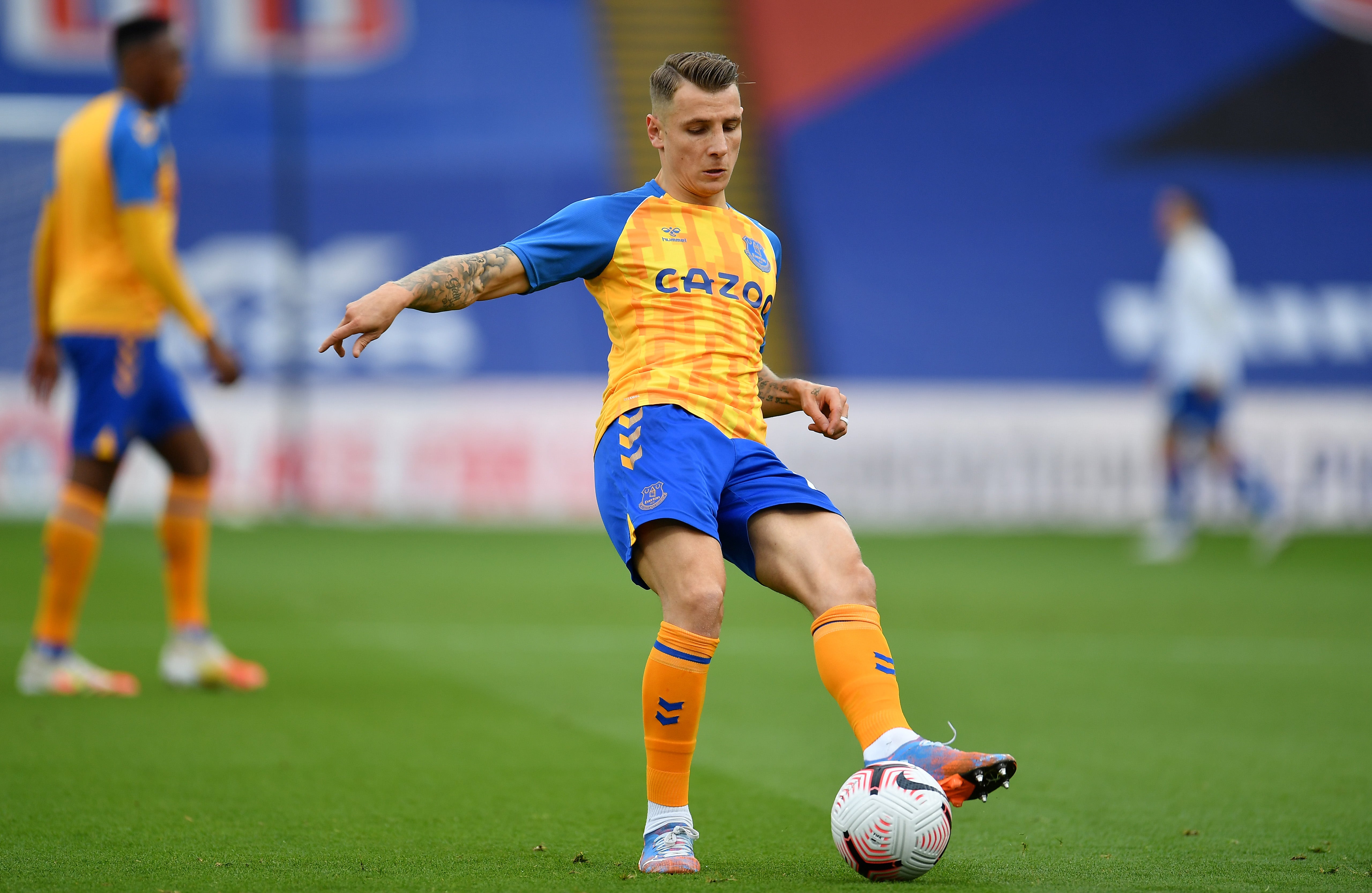 Lucas Digne warms up before kick-off in south London
