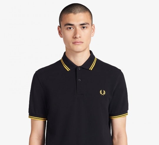 Proud Boys has adopted the iconic Fred Perry polo T-shirt, pictured above