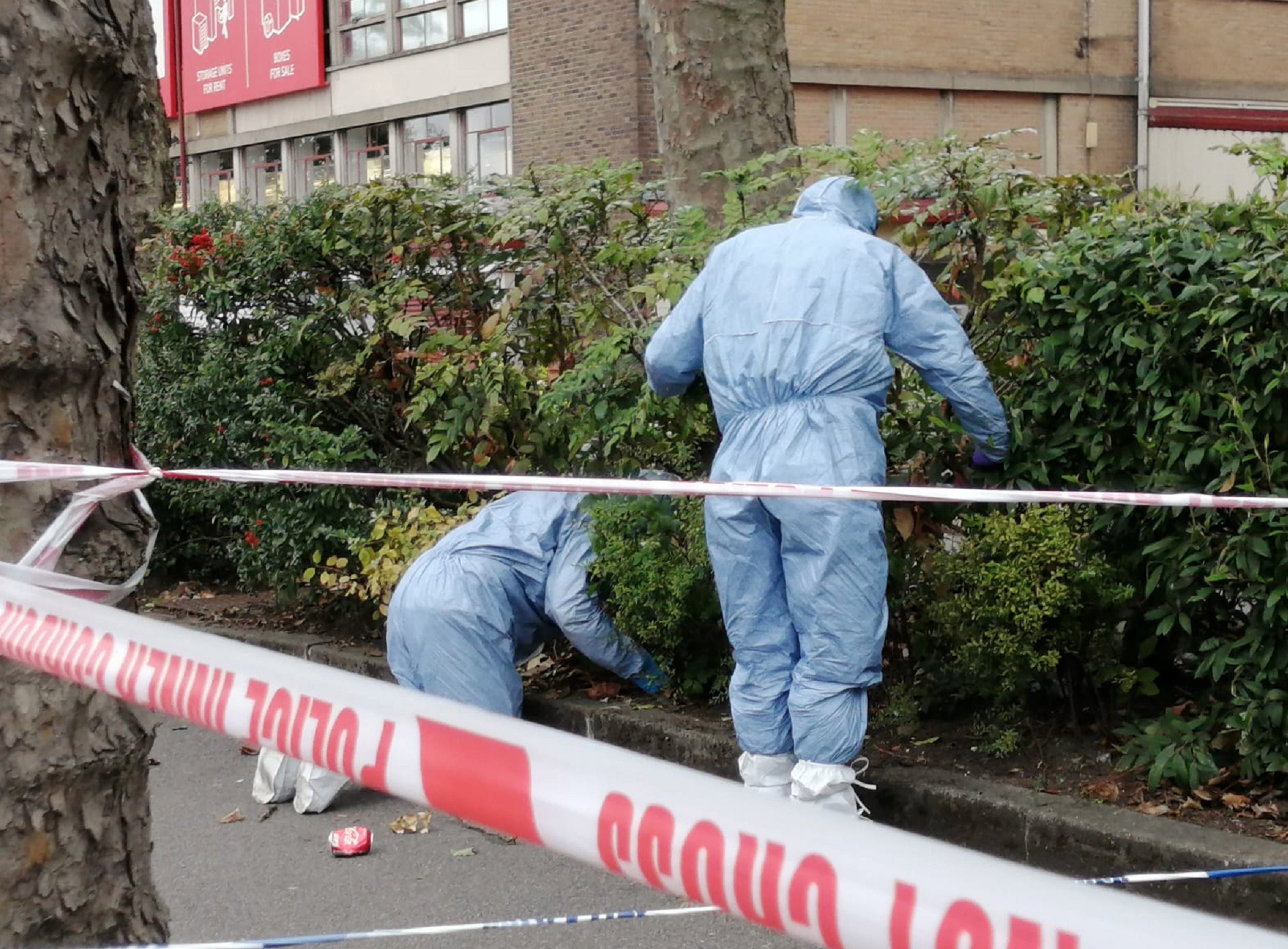 Police search a crime scene in Croydon after the fatal shooting of an officer