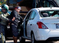 Woman arrested after driving car into California protest
