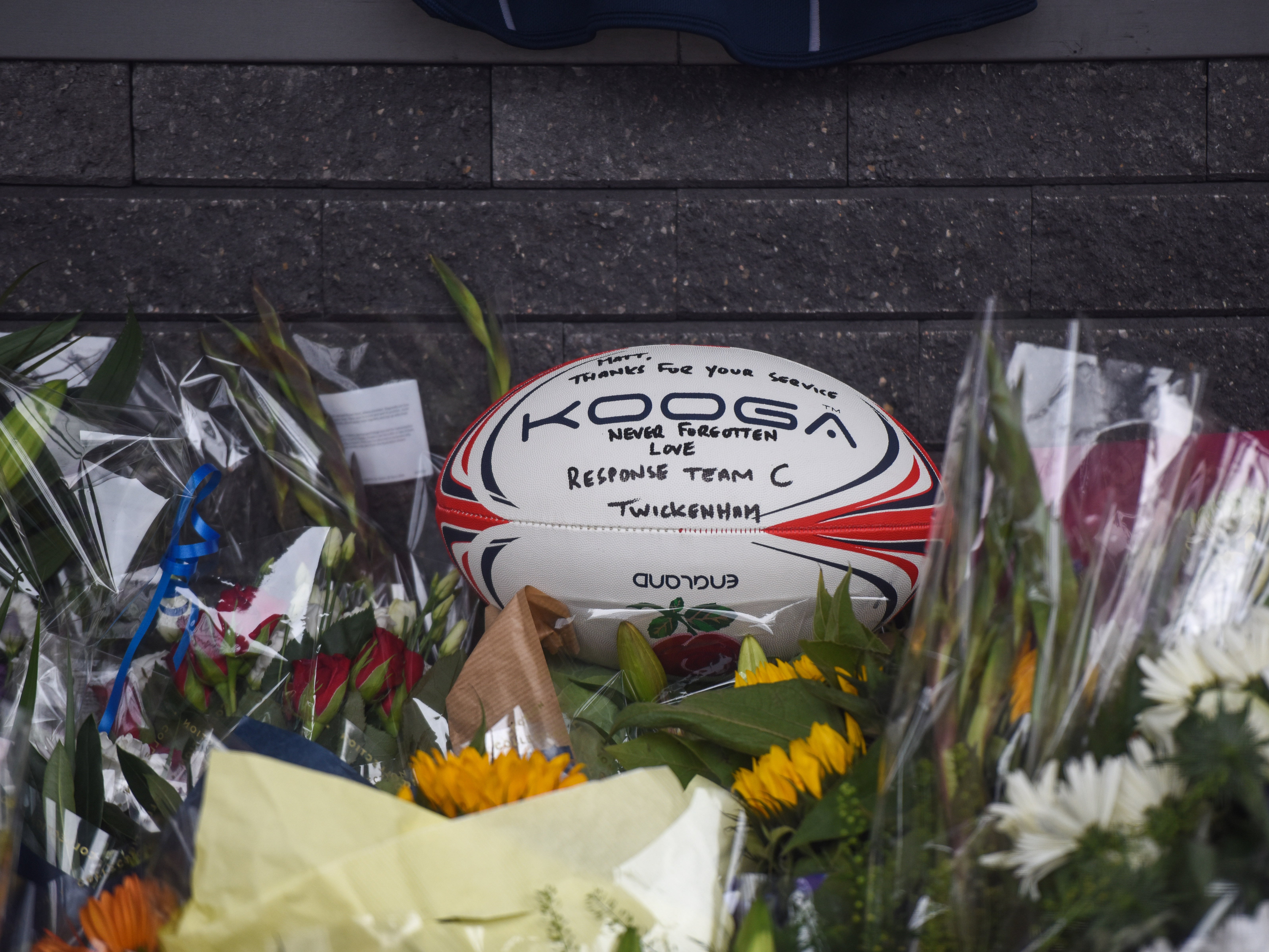Tributes to sergeant Matiu Ratana are seen outside Croydon Custody Centre on Sunday