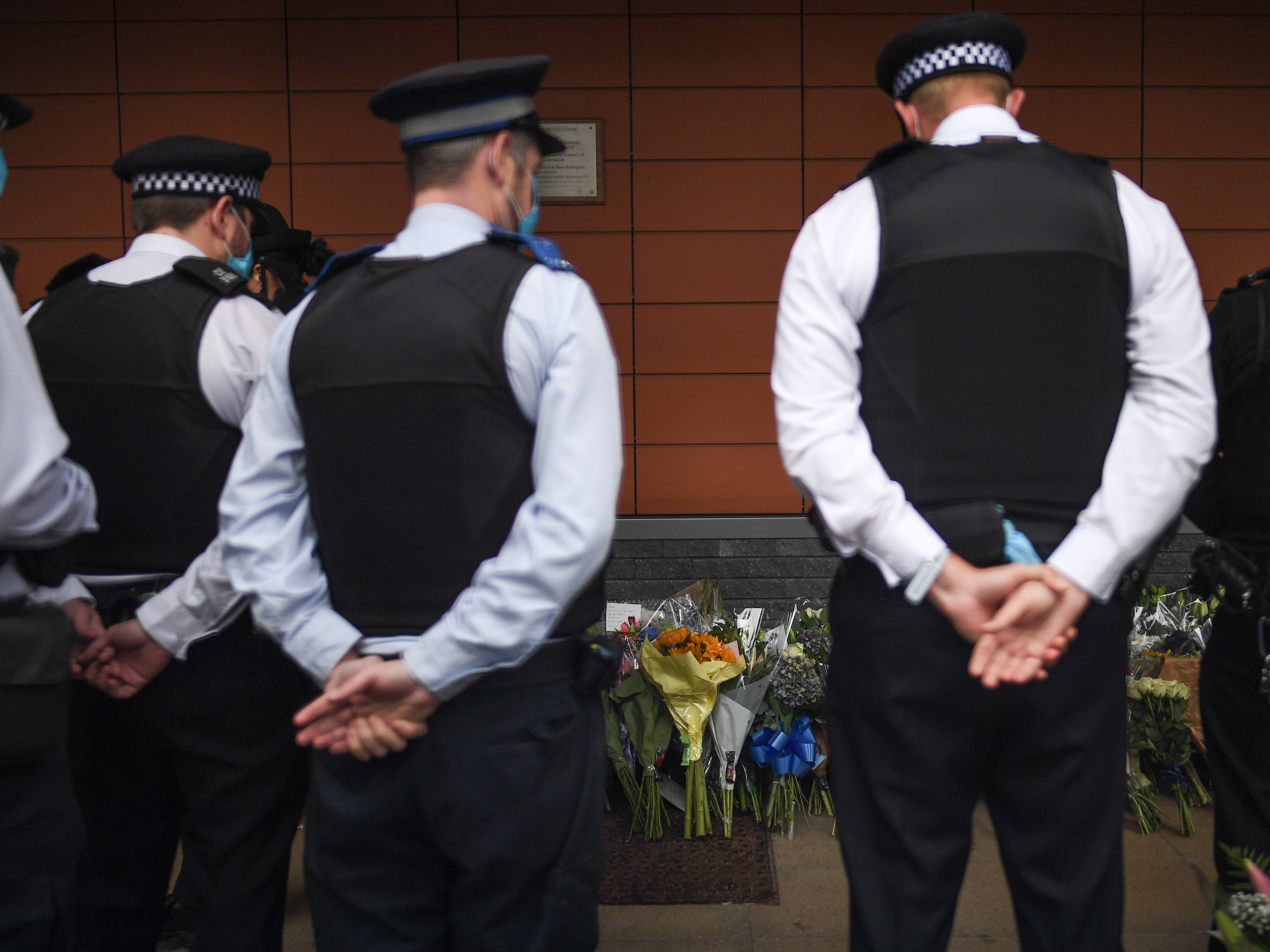 Police officers leave tributes to Sergeant Matiu Ratana outside Croydon Custody Centre