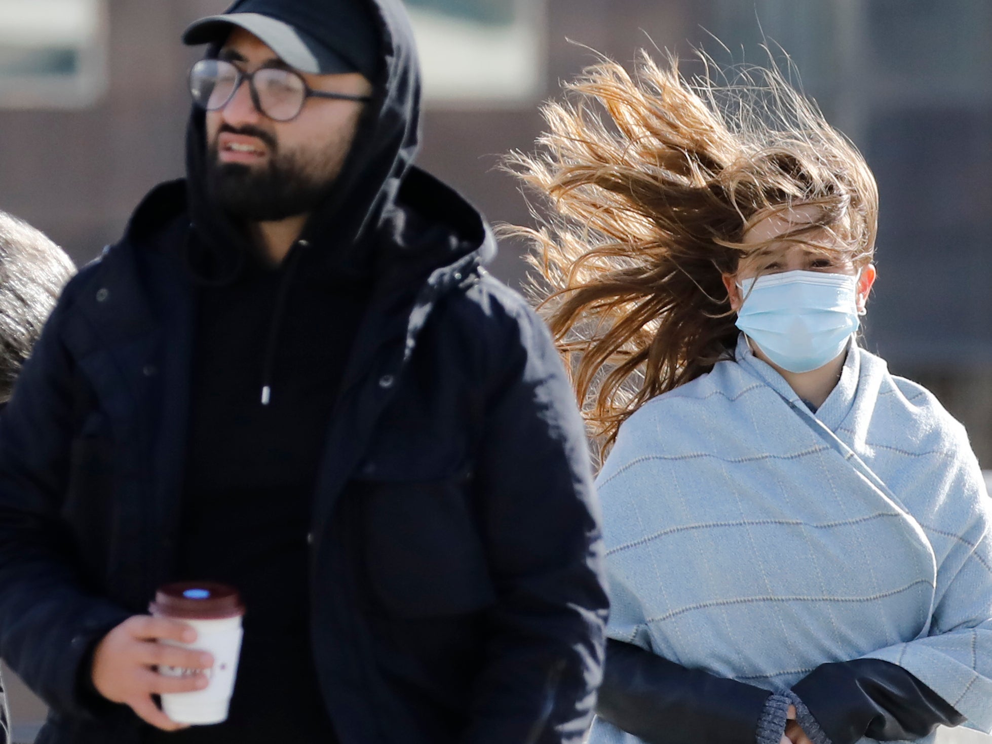 Pedestrians face windy conditions as they cross London Bridge in central London over the weekend